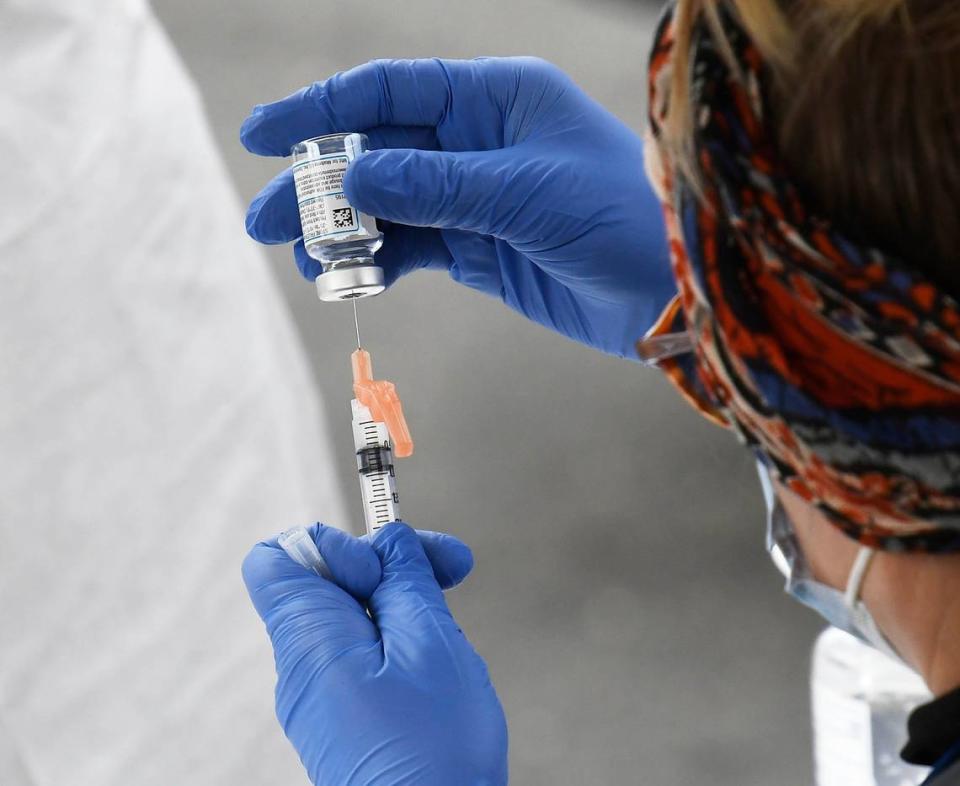 A Mecklenburg County Public Health professional prepares a COVID vaccination during a drive through event at he C.W. Williams Community Health Center on Friday, January 22, 2021. C.W. Williams Community Health Center, along with the Mecklenburg County Public Health Department offered patients of the health center COVID vaccinations through appointments.