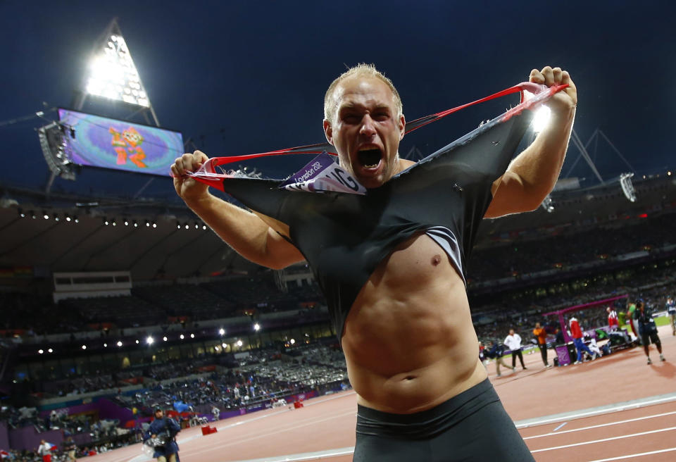 Germany's Robert Harting rips his shirt as he celebrates winning the men's discus throw final during the London 2012 Olympic Games at the Olympic Stadium August 7, 2012. Harting won gold ahead of Iran's Ehsan Hadadi who took silver and Estonia's Gerd Kanter who won bronze. REUTERS/Kai Pfaffenbach (BRITAIN - Tags: SPORT ATHLETICS OLYMPICS TPX IMAGES OF THE DAY) 