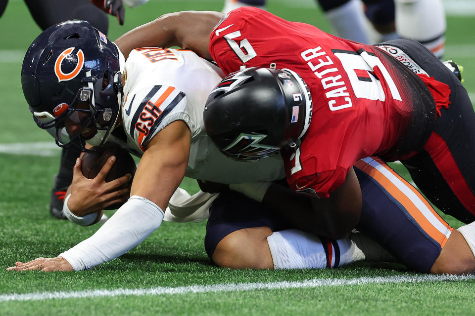 ATLANTA, GEORGIA - NOVEMBER 20: Lorenzo Carter #9 of the Atlanta Falcons tackles Justin Fields #1 of the Chicago Bears during the third quarter at Mercedes-Benz Stadium on November 20, 2022 in Atlanta, Georgia. (Photo by Kevin C. Cox/Getty Images)