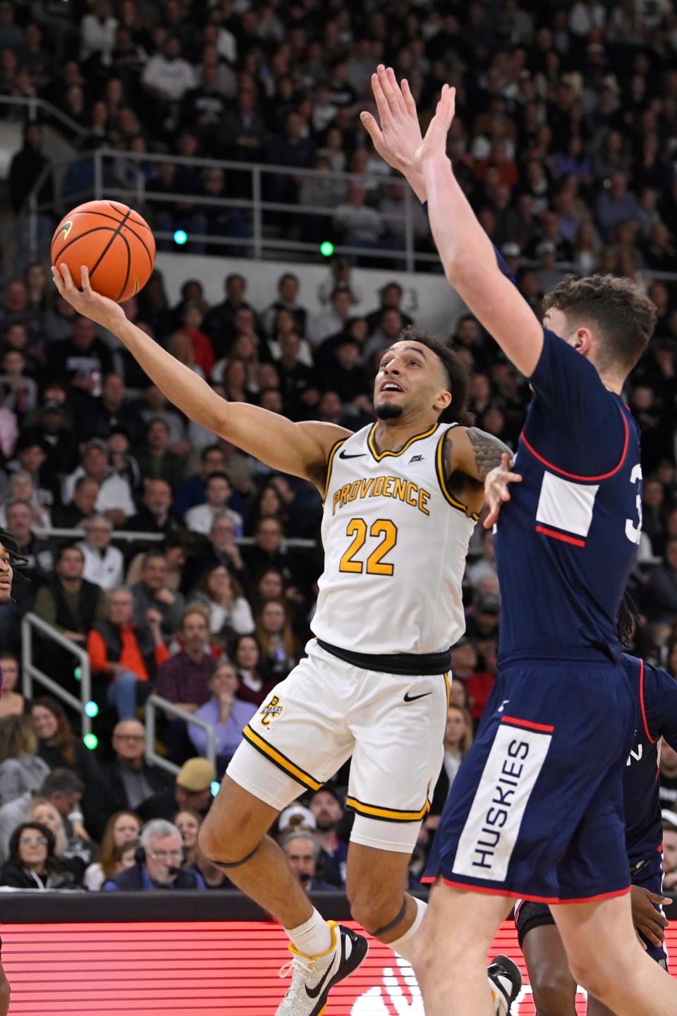 Providence guard Devin Carter (22) shoots a layup against the Connecticut Huskies during the first half of Saturday's game at the AMP. Carter and Friars open tournament play Wednesday in New York.