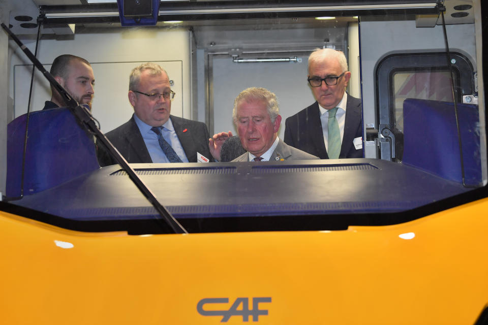 The Prince of Wales sitting in the drivers seat of a train being constructed during a visit to the CAF train factory in Newport, Wales.