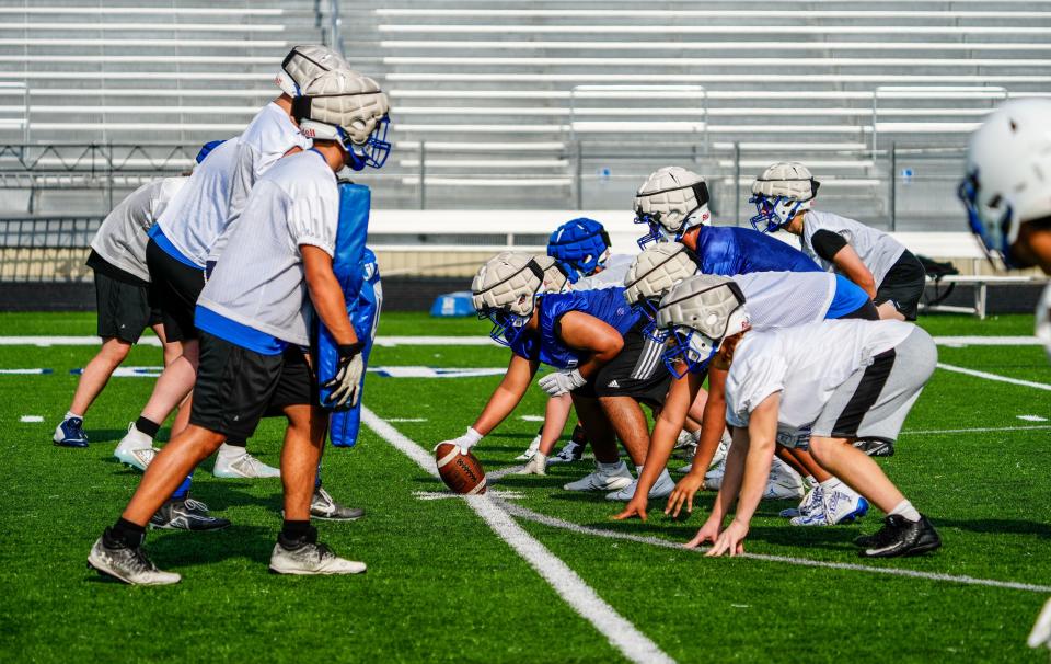 Brookfield Central quarterback AJ Seymour runs a play during the first day of high school football practice on Tuesday, August 1, 2023.