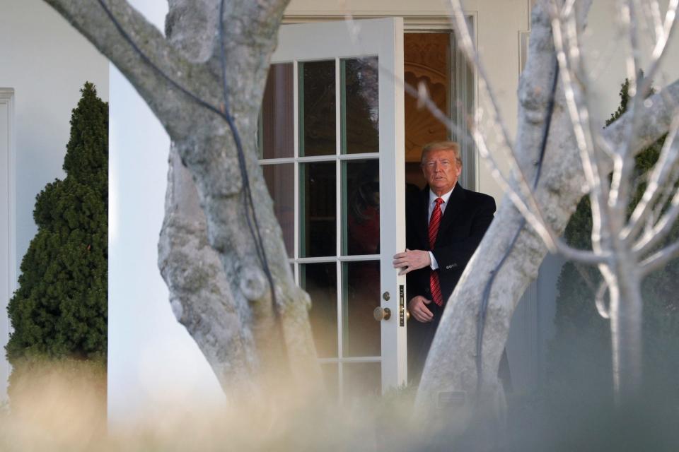 President Donald Trump at the door of the White House.