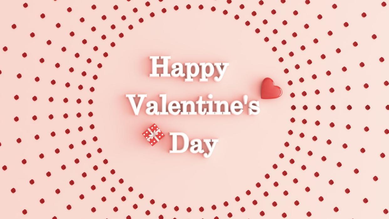 heart, gift, and white letters spelling happy valentine's day on pink surface encircled by red dots arranged in spoke pattern