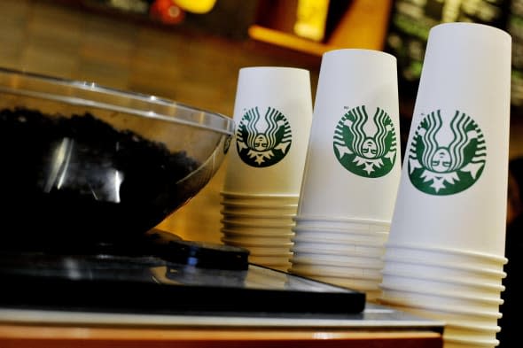 File photo dated 13/08/2013 of Starbucks takeaway cups at a  Starbucks in central London, as the coffee shop chain announced it is moving its European headquarters from the Netherlands to the UK following a row over tax avoidance. PRESS ASSOCIATION Photo. Issue date: Wednesday April 16, 2014. Starbucks announced it would 