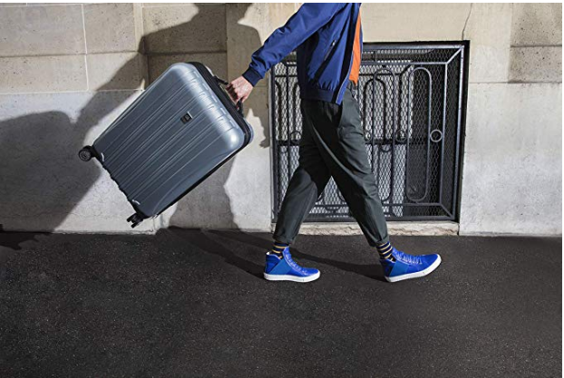 person holding suitcase