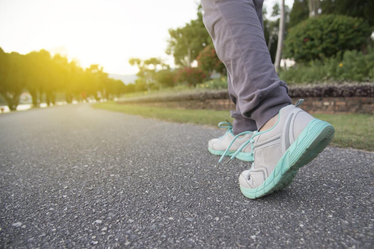 Road to success,running on road with sports shoes,healthy lifestyle sports woman running, female legs with sneakers jogging in evening prepare for marathon