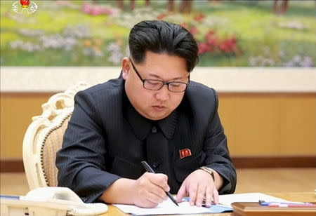 North Korean leader Kim Jong Un signs a document regarding the test of a hydrogen bomb, in this still image taken from KRT video and released by Yonhap on January 6, 2016. REUTERS/Yonhap