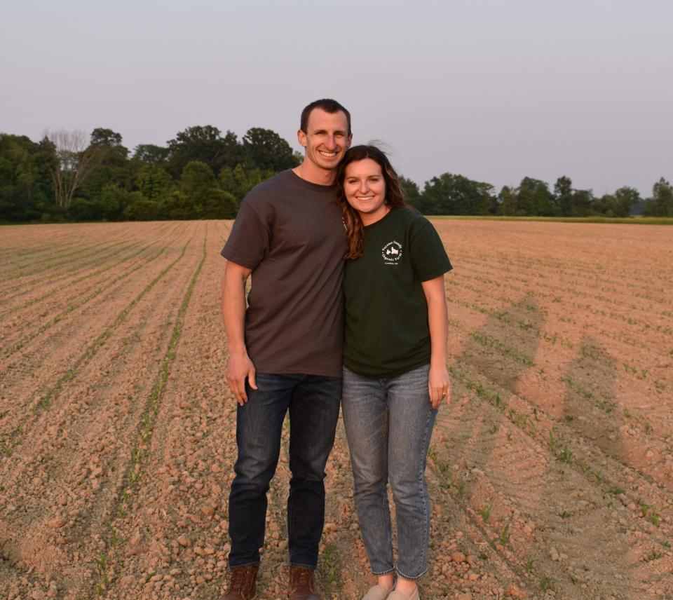 Adam and Amanda Paynter stand in the cornfield at Paynter Family Organic Farm in Crestline. In addition to raising poultry, Adam's day job is as a physical therapist for Avita Health System at the outpatient clinic in Bucyrus.