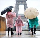 Tourists stroll on the Trocadero square, in front of the Eiffel Tower during a rainy day in Paris, France, May 30, 2016. REUTERS/Charles Platiau