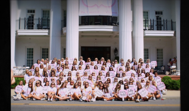 A sorority posing in front of their house