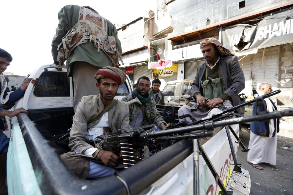 Houthi rebel fighters wait outside former President Ali Abdullah Saleh's residence in Sanaa on Monday. (Photo: MOHAMMED HUWAIS via Getty Images)