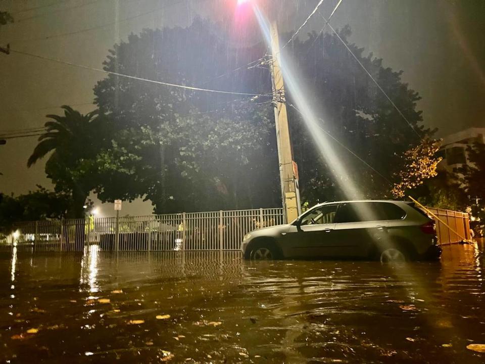 An abandoned BMW sits in floodwater on Normandy Isle, one of several vehicles that broke down while drivers tried to navigate the waterlogged island community during Wednesday’s deluge.