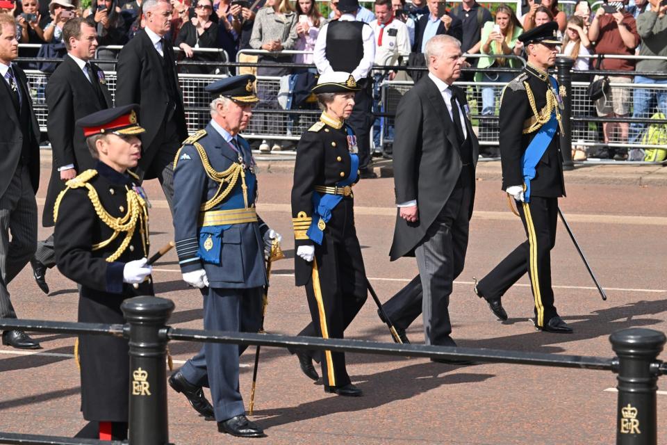 King Charles III, Princess Anne, Princess Royal, Prince Andrew, Duke of York and Prince Edward, Earl of Wessex walk behind the coffin during the procession for the Lying-in State of Queen Elizabeth II