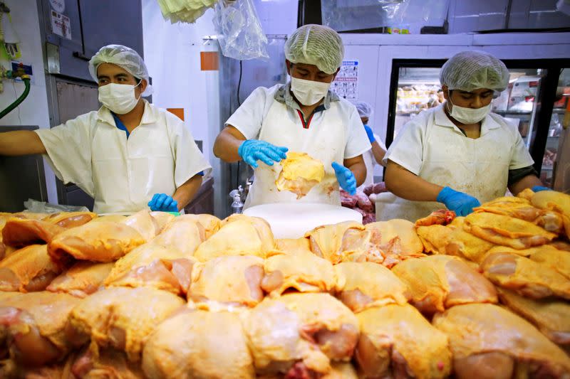 FILE PHOTO: Workers prepare chicken at a food stall in the Central de Abastos wholesale market in Mexico City