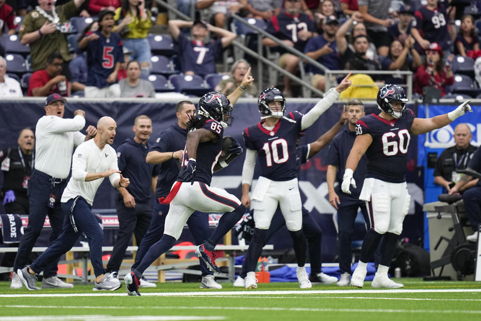 Houston Texans wide receiver Noah Brown (85) runs by his bench on the way to scoring on a long touchdown reception against the Tampa Bay Buccaneers during the second half of an NFL football game, Sunday, Nov. 5, 2023, in Houston. (AP Photo/Eric Gay)