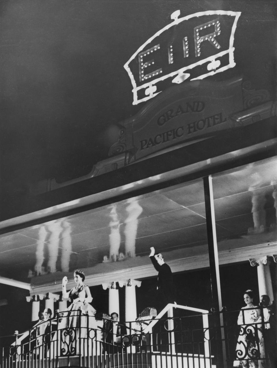 Queen Elizabeth II and Prince Philip waved to crowds from the balcony of the Grand Pacific Hotel in Suva, Fiji, during the Quen’s coronation world tour in 1953. Photo: Getty