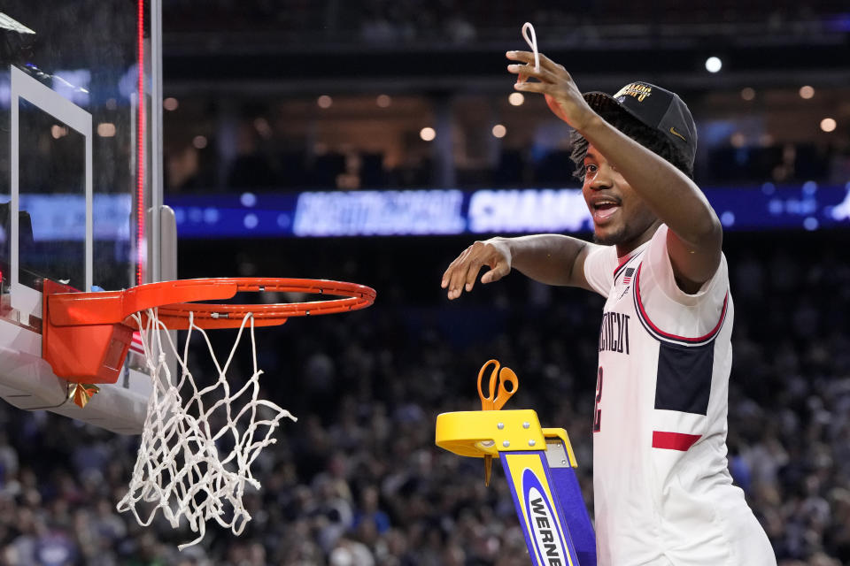 Connecticut guard Tristen Newton celebrates during the net cutting after their win against San Diego State in the men's national championship college basketball game in the NCAA Tournament on Monday, April 3, 2023, in Houston. (AP Photo/David J. Phillip)