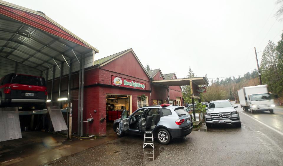 Cars are parked outside the Green Light Garage on Bainbridge Island, near the portion of Eagle Harbor Drive being considered for a bicycle lane that would provide a safer commute.