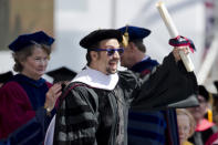 FILE - In this May 16, 2016 file photo Lin-Manuel Miranda, creator of the Broadway musical "Hamilton," reacts after receiving an honorary degree during the University of Pennsylvania commencement ceremony in Philadelphia. Miranda, who was everywhere in popular culture this year, was named The Associated Press Entertainer of the Year, voted by members of the news cooperative. (AP Photo/Matt Rourke, File)