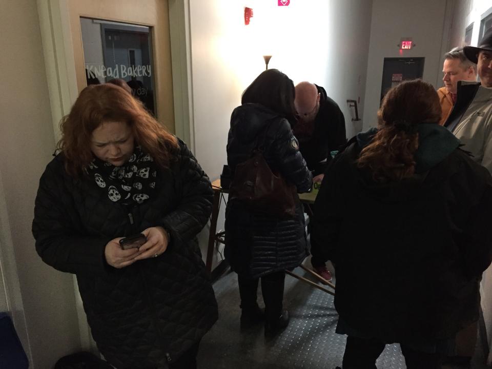 Laura Roald, board president for the Off Center for the Dramatic Arts in Burlington, posts on social media as a crowd gathers for a performance of "The Stick Wife" on Feb. 1, 2019.