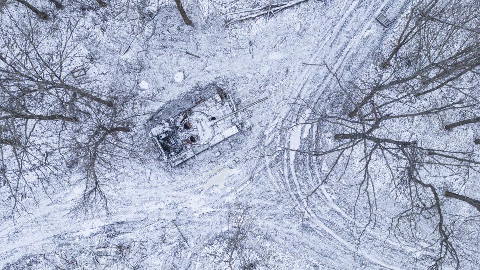 A destroyed Russian tank covered by snow stands in a forest in the Kharkiv region of Ukraine on Jan. 14, 2023. (Evgeniy Maloletka/AP)