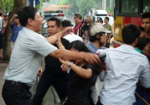 Plainclothed police officers arrest and push protesters into a bus during a brief anti-China rally in the centre of Hanoi on August 21. At least eight political activists have been arrested on subversion charges in Vietnam, their legal adviser said, in a crackdown that began after the prime minister was re-appointed