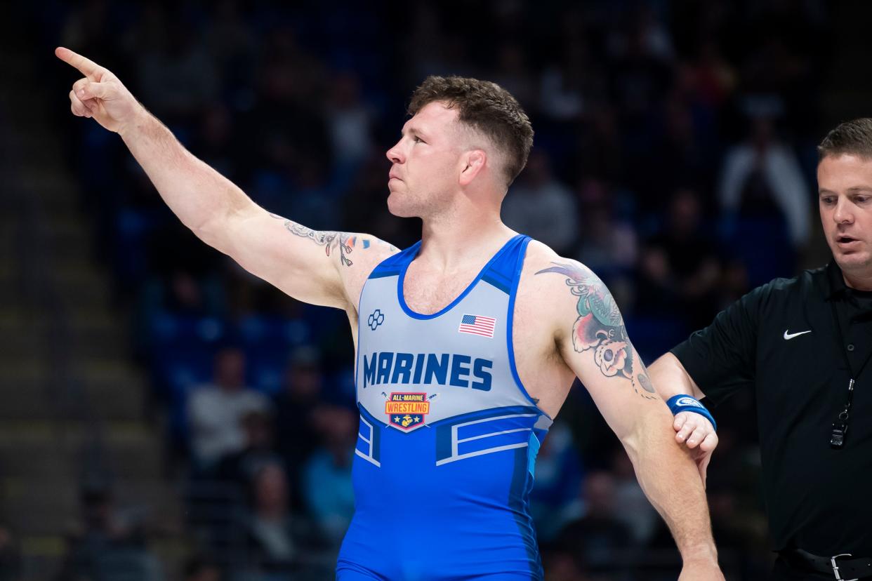 John Stefanowicz points to the stands after winning his 87 kilogram challenge round quarterfinal bout during the U.S. Olympic Team Trials at the Bryce Jordan Center April 19, 2024, in State College. Stefanowicz defeated Tim Young by tech fall, 8-0.