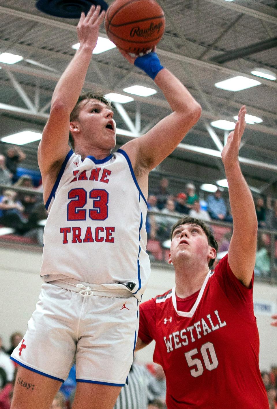 Zane Trace's Carter Langley (23) puts up the shot over Westfall's Jerry Layton (50) in varsity boys basketball action at Zane Trace High School on Feb. 13, 2024, in Chillicothe, Ohio. Zane Trace defeated Westfall 52-40.