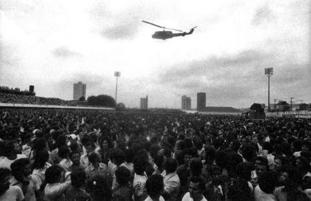 Members of the metalworkers union, mostly employed by the automobile and truck industry, hold an assembly as a helicopter sent to intimidate them by the governing military dictatorship flies overhead, in Sao Bernardo do Campo, near Sao Paulo, in 1980. REUTERS/Joao Bittar