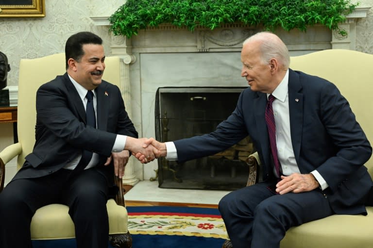 US President Joe Biden (R) shakes hands with the Prime Minister of Iraq Mohammed Shia al-Sudani in the Oval Office of the White House in Washington, DC on April 15, 2024. Sudani's trip to Washington, his first since taking office in October 2022, was originally expected to focus on the presence of US troops in Iraq as part of an anti-jihadist coalition. But the meeting will now be dominated by the fractious situation in the region after Iraq's neighbor Iran launched a massive missile and drone assault on Israel on April 13, 2024. (ANDREW CABALLERO-REYNOLDS)