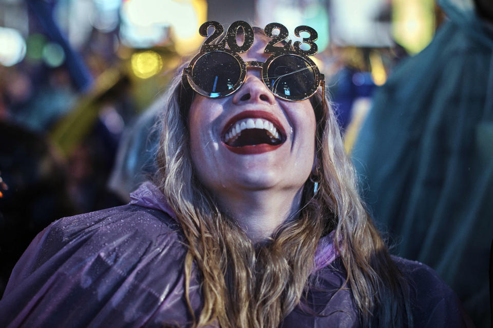 A reveler laughs as she waits for the countdown during the New Year's Eve celebrations in Times Square, late Saturday, Dec. 31, 2022, in New York. (AP Photo/Andres Kudacki)