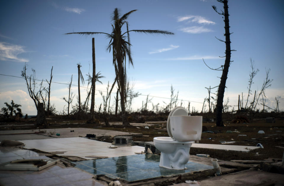 A toilet stands amid the rubble of what was once a home after it was destroyed by Hurricane Dorian one week ago in Pelican Point, Grand Bahama, Bahamas, Sunday, Sept. 8, 2019. The toll from the storm in the Bahamas stood at 44 Monday but officials have warned that the number of deaths is likely to rise as security forces and other teams search devastated areas of the northern Bahamas. (AP Photo/Ramon Espinosa)