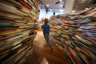 A child runs in the 'aMAZEme' labyrinth made from books at The Southbank Centre on July 31, 2012 in London, England. (Photo by Peter Macdiarmid/Getty Images)
