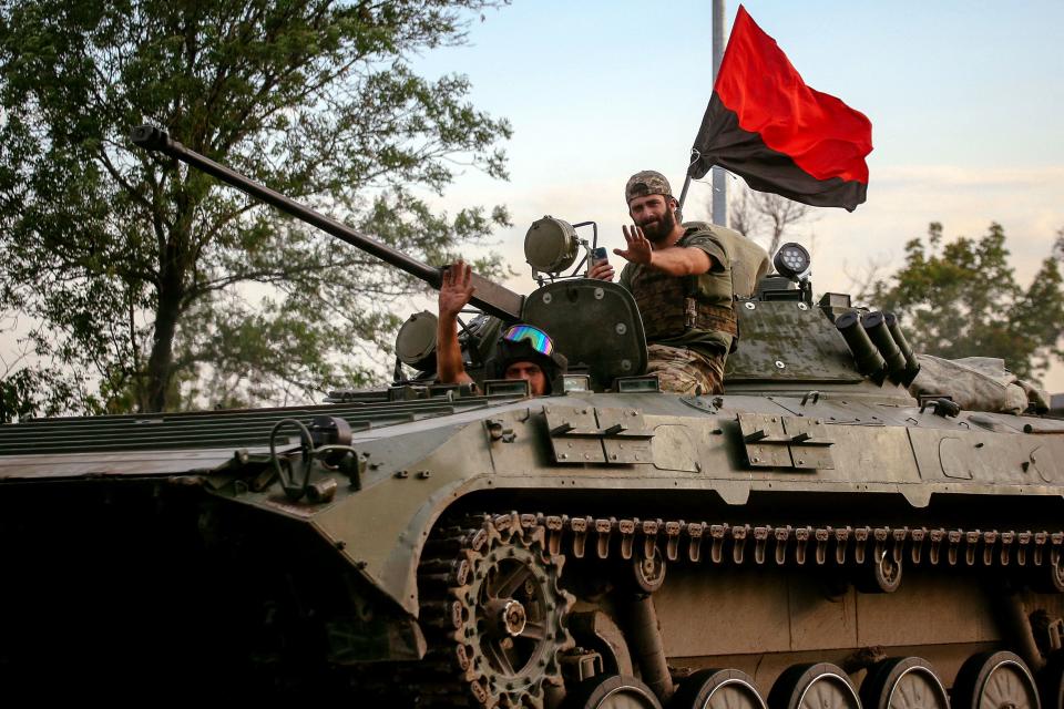 Ukrainian soldiers ride an armoured personnel carrier (APC) on a road in the Donetsk region on August 13, 2022, amid the Russian military invasion of Ukraine. (Photo by ANATOLII STEPANOV / AFP) (Photo by ANATOLII STEPANOV/AFP via Getty Images)