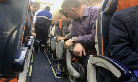 Police officers detain a man after failed attempt to hijack plane, Khanty-Mansiysk, Russia January 22, 2019 in this image obtained from a social media on January 22, 2019. MAXIM TVERITNEV/via REUTERS