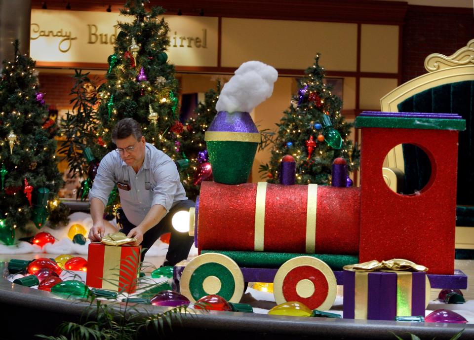 Steve Selanak, a building maintainence worker at Southridge Mall, checks the placement of presents in 2009 during final adjustments for the Santa's throne display in preparation for Santa's arrival.