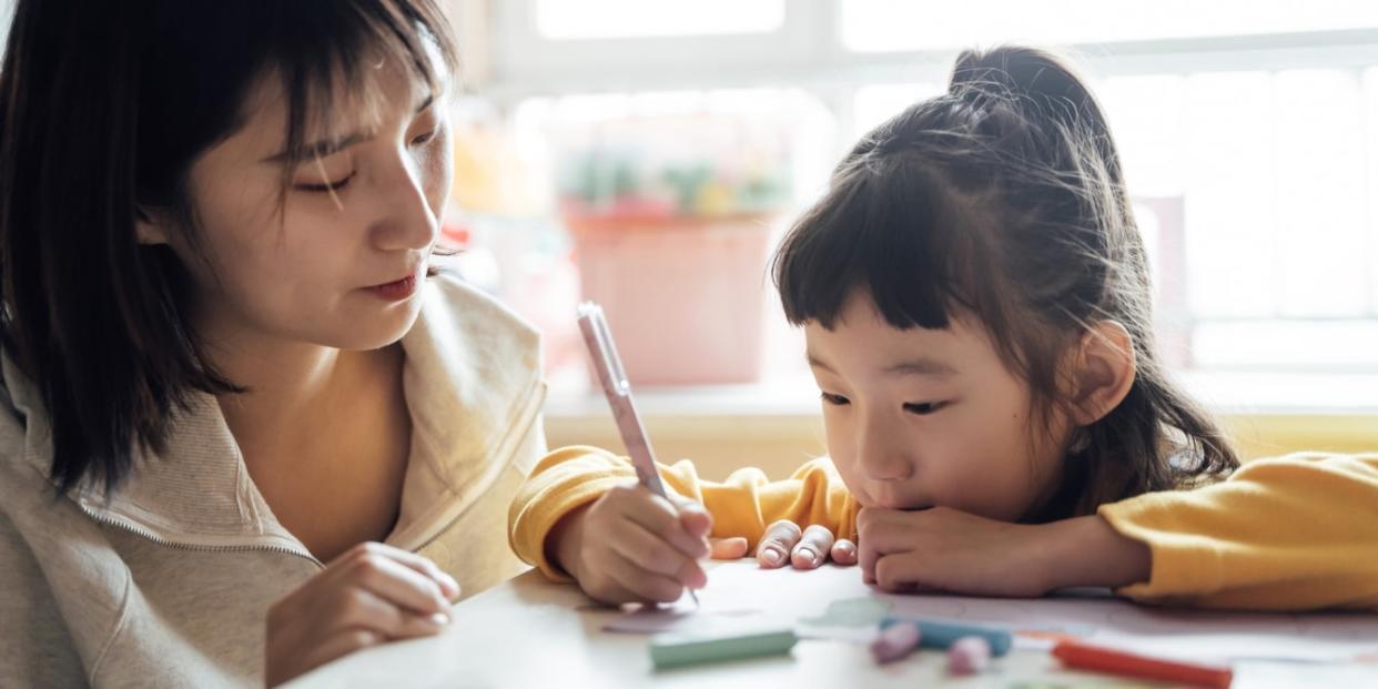 Asian mom and daughter coloring at table - time blindness