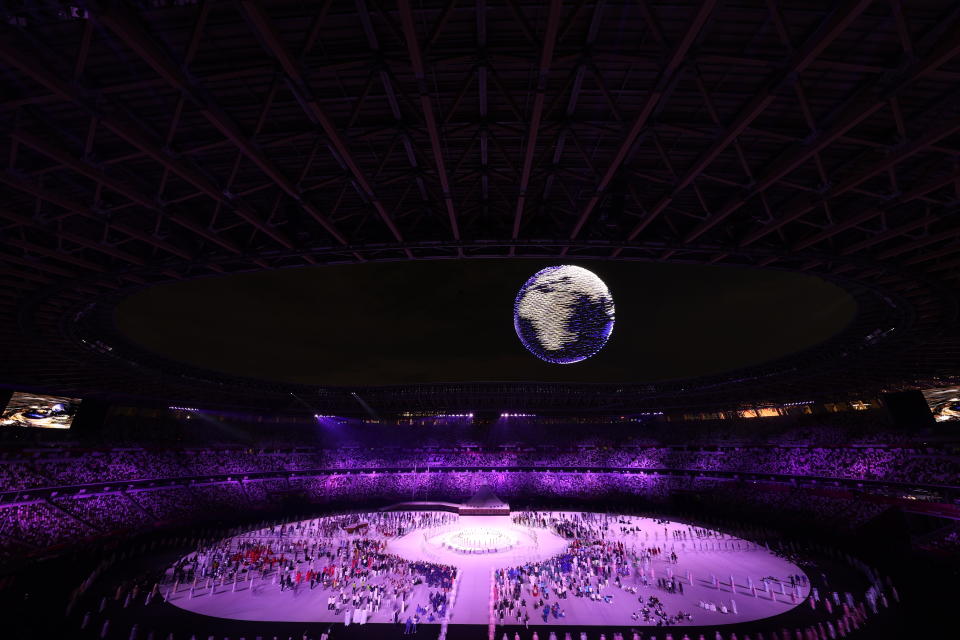 TOKYO, JAPAN - JULY 23: A drone display is seen over the top of the stadium during the Opening Ceremony of the Tokyo 2020 Olympic Games at Olympic Stadium on July 23, 2021 in Tokyo, Japan. (Photo by Laurence Griffiths/Getty Images)