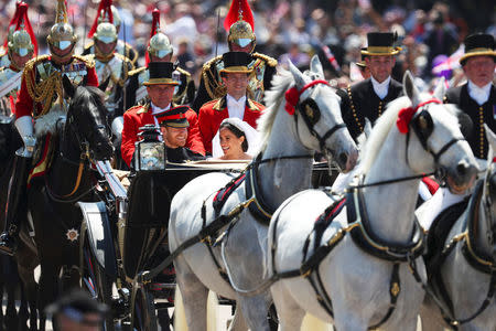 Britain's Prince Harry and his wife Meghan Markle ride a horse-drawn carriage, after their wedding ceremony at St George's Chapel in Windsor, Britain, May 19, 2018. REUTERS/Hannah McKay/Pool