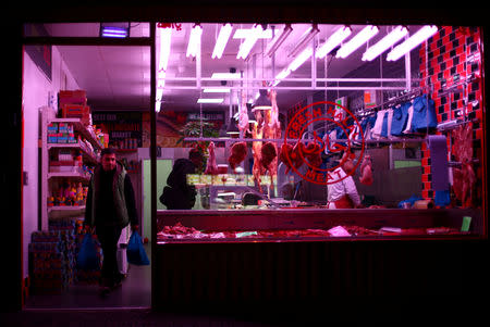 A mean leaves a halal butcher shop in Dagenham, east London, Britain, March 18, 2019. REUTERS/Hannah McKay