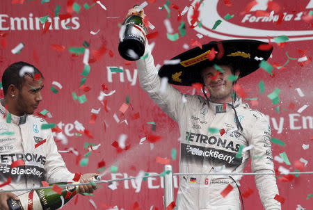 Mercedes Formula One driver Nico Rosberg (R) of Germany celebrates next to his teammate Lewis Hamilton of Britain after winning the Mexican F1 Grand Prix at Autodromo Hermanos Rodriguez in Mexico City, November 1, 2015. REUTERS/Edgard Garrido