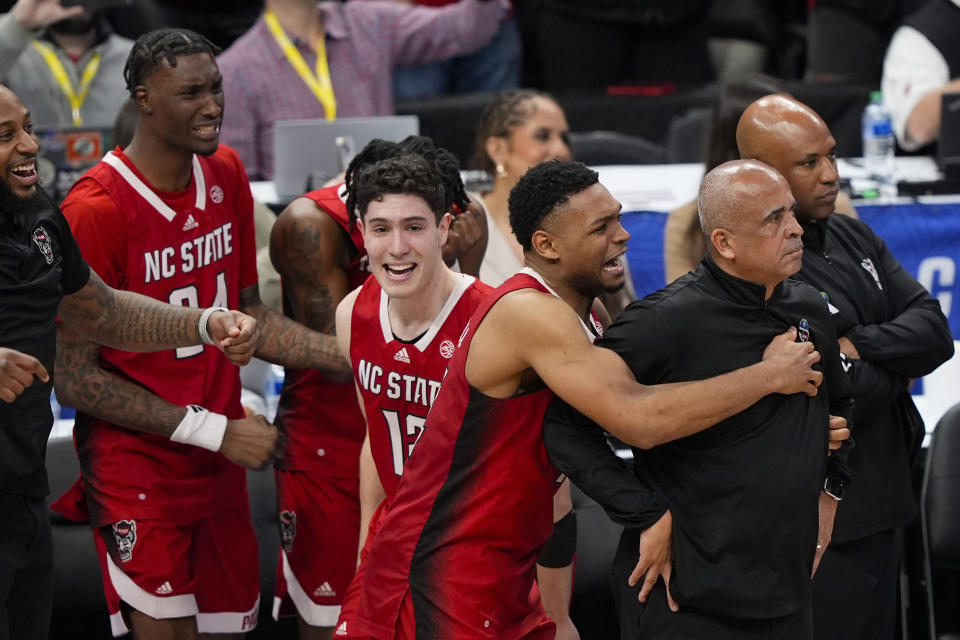 North Carolina State players and coaches celebrate thier win against North Carolina in an NCAA college basketball championship game of the Atlantic Coast Conference tournament, Saturday, March 16, 2024, in Washington. North Carolina State won 84-76. (AP Photo/Susan Walsh)