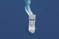 Indonesian Navy hospital ship KRI Dr. Soeharso sails during a search for submarine KRI Nanggala that went missing while participating in a training exercise on Wednesday, in this photo taken from a maritime patrol aircraft of 800 Air Squadron of the 2nd Air Wing of Naval Aviation Center (PUSPENERBAL) over the waters off Bali Island, Indonesia, Thursday, April 22, 2021. Indonesia's navy ships on Thursday were intensely searching for the submarine that likely fell too deep to retrieve, making survival chances for all the crew on board slim. Authorities said oxygen in the submarine would run out by early Saturday. (AP Photo/Eric Ireng)