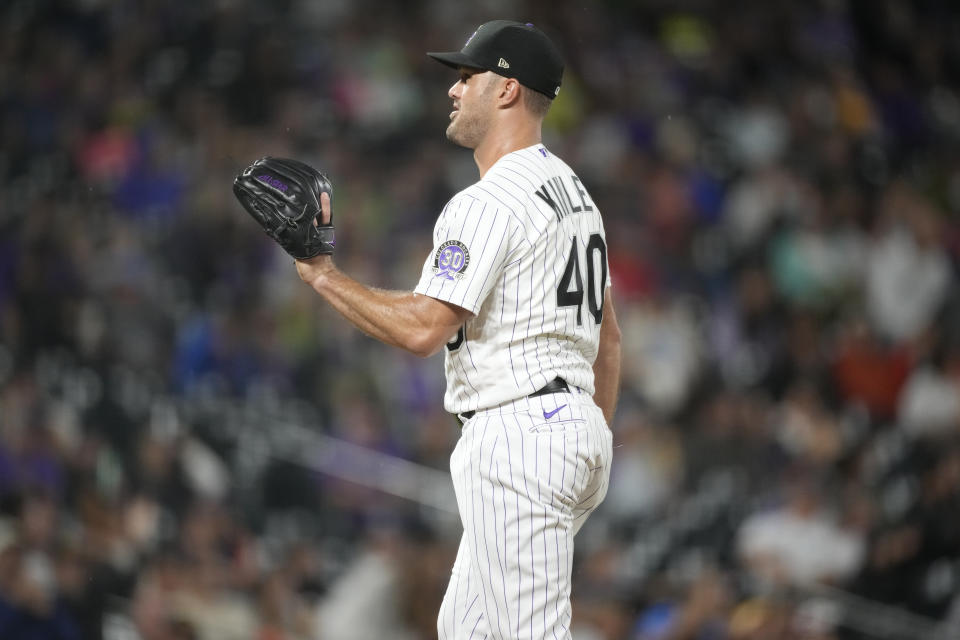 Colorado Rockies relief pitcher Tyler Kinley calls for a new ball after giving up a solo home run to San Diego Padres' Juan Soto in the eighth inning of a baseball game Tuesday, Aug. 1, 2023, in Denver. (AP Photo/David Zalubowski)