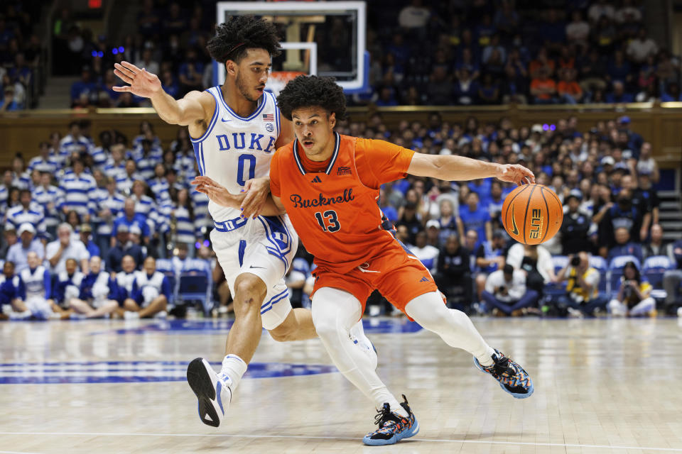 Bucknell's Josh Bascoe (13) dribbles as Duke's Jared McCain (0) defends during the first half of an NCAA college basketball game in Durham, N.C., Friday, Nov. 17, 2023. (AP Photo/Ben McKeown)