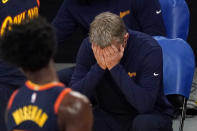 Golden State Warriors head coach Steve Kerr, right, puts his head in his hands after his team was charged with an offensive foul during the first half of an NBA basketball game against the Los Angeles Lakers Sunday, Feb. 28, 2021, in Los Angeles. (AP Photo/Mark J. Terrill)