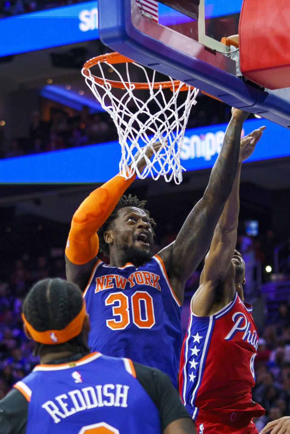 New York Knicks' Julius Randle, center, shoots against Philadelphia 76ers' De'Anthony Melton, right, during the first half of an NBA basketball game Friday, Nov. 4, 2022, in Philadelphia. (AP Photo/Chris Szagola)