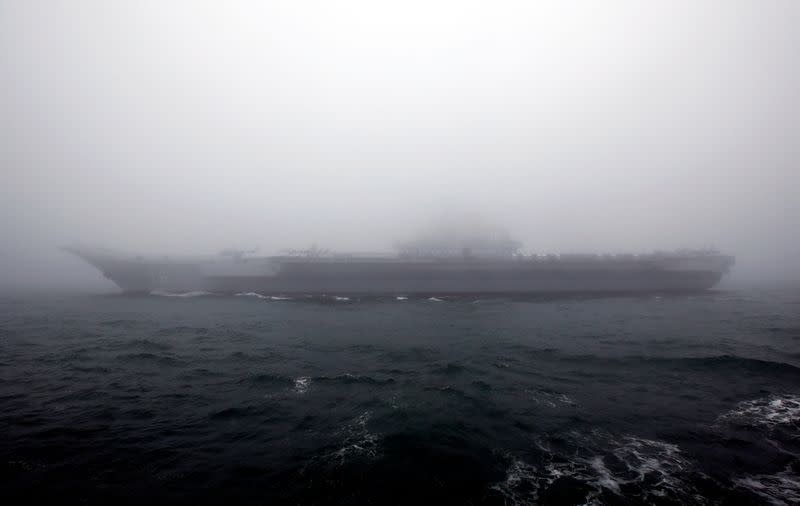 FILE PHOTO: Chinese Navy’s Aircraft carrier Liaoning takes part in a naval parade off the eastern port city of Qingdao, to mark the 70th anniversary of the founding of Chinese People's Liberation Army Navy