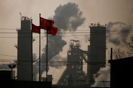 FILE PHOTO: Chinese national flags are flying near a steel factory in Wu'an, Hebei province, China, February 23, 2017. REUTERS/Thomas Peter/File Photo